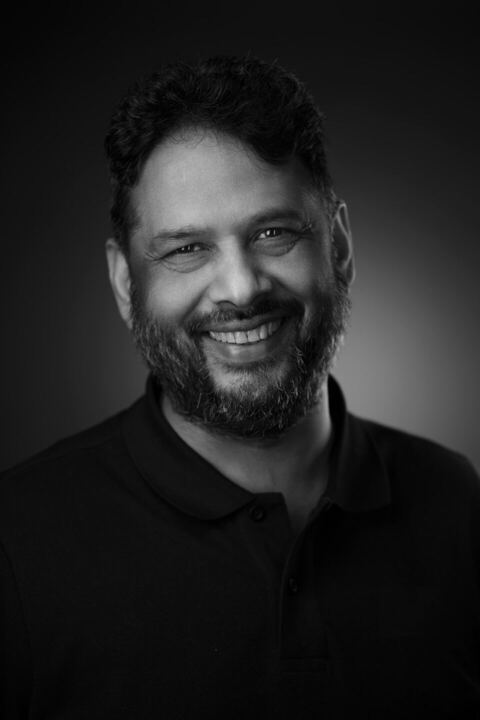 Black and white portrait of Daksh Kumar, smiling